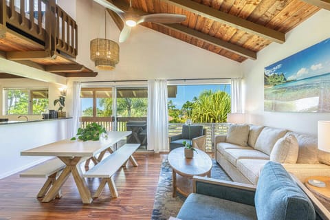 Distant ocean-view lanai seating. Enjoy your morning coffee while taking in tropical views.