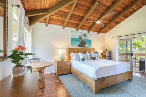 Wake up in comfort. The king-sized bed and wood-beamed ceiling bring cozy charm to this breezy retreat.