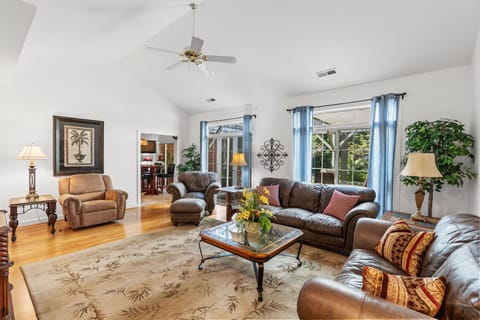 Bright living room with cozy seating, TV, and charm, great for relaxing.