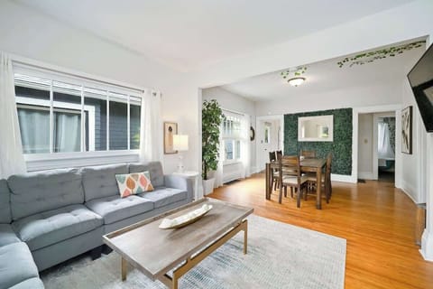 Living room with sofa seating and dining nearby.
