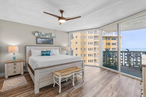 Wake up to stunning beach views in this serene coastal bedroom featuring a king bed, natural light, and private balcony access—perfect for a peaceful seaside escape.