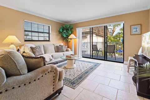 Bright & airy living room with sliding glass doors that lead to outdoor balcony