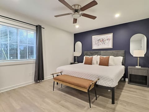 Step into an inviting bedroom in a furnished apartment, adorned with calming blue walls and soft, plush bedding. Enjoy the gentle glow of the bedside lamps, creating the perfect ambiance for unwinding after a long day.