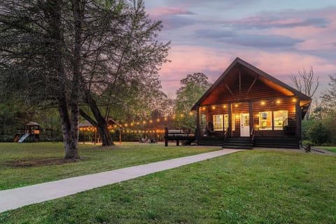 Welcome to Runway Retreat—your private aviation-themed cabin on 75+ secluded acres, featuring a spacious deck, string-lit fire pit, hot tub, and a playground, all nestled against a stunning Pennsylvania sunset backdrop.