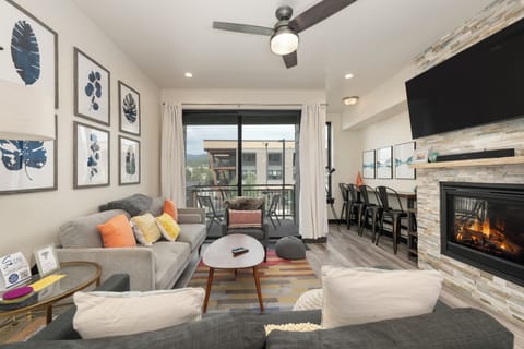 Relax in your stylish living space with cozy fireplace, modern furnishings, and stunning mountain views from your private balcony.