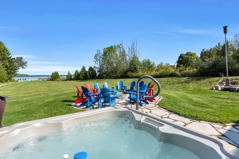 Welcome to Romeo Resort. Soak in the hot tub while overlooking the firepit and waterfront, where unforgettable moments are made with family and friends.