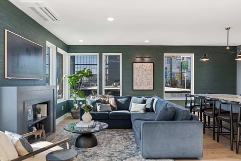 Spacious and inviting living room with plush seating, modern fireplace, and natural light.