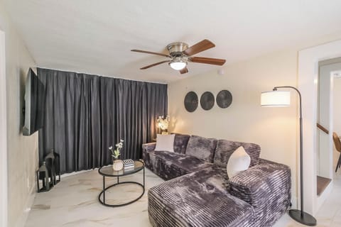 Living room with cozy sofa & Smart TV.