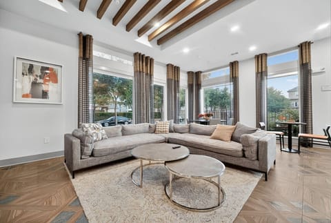 Shared Gathering Room: Bright and inviting space with sleek furniture and large windows for stunning views!