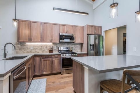 The fully equipped kitchen at Lani Oasis features stainless steel appliances, ample counter space, and modern finishes.