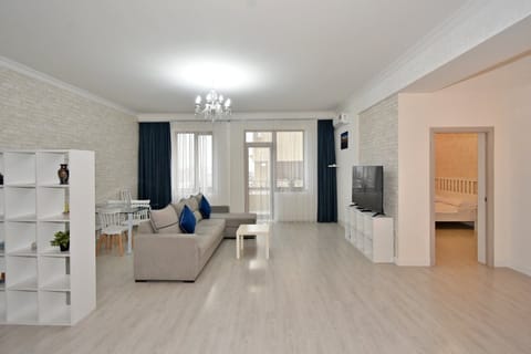 Deluxe Apartment, City View | Living area | 50-inch flat-screen TV with cable channels