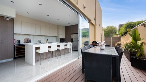 	Indoor-outdoor perfection! The fully-equipped gourmet kitchen flows directly onto the private terrace, complete with a BBQ and outdoor dining set.