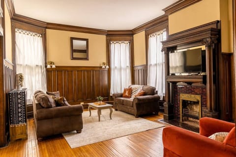 Relax with friends in this inviting living room, perfect for conversation or cozy nights by the fireplace.