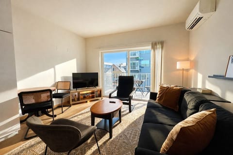 Unwind in the sun-drenched living area, complete with a dining table/workspace and a private balcony for your morning coffee