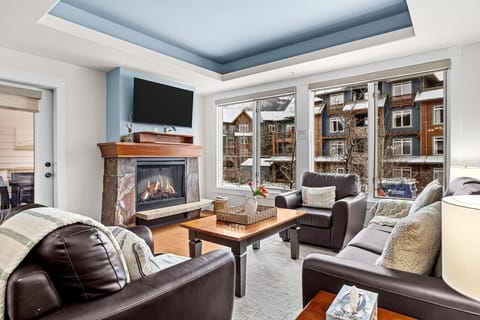 Spend quality time with your loved ones in this inviting living area furnished with cozy seating, a fireplace and a flat-screen TV.