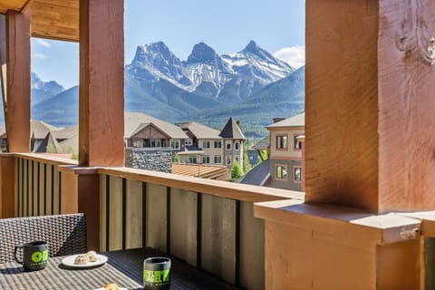 Enjoy serene mountain views from a cozy private balcony with outdoor seating.