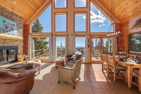 Enjoy walk out access to the elevated, wraparound deck, and a large dining room table with comfortable seating for 6.