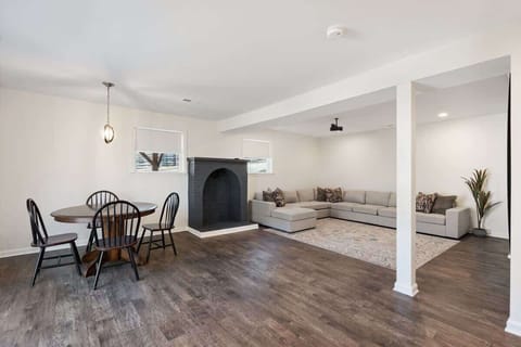 Combined living and dining space with fireplace and hardwood floors