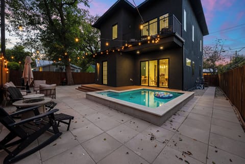 Backyard view with plunge pool, BBQ grill, and seating.