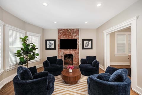 Cozy living room with brick fireplace and smart TV.