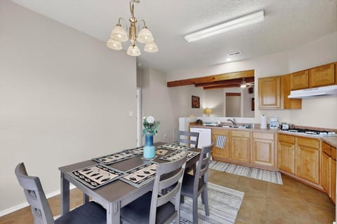 Enjoy meals in a modern dining area with a rustic table and comfy seating.