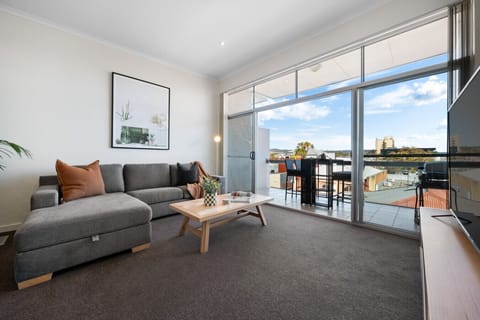 A bright and spacious living area offers comfortable seating and seamlessly flows out to your private balcony.