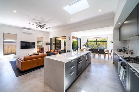 Relax in the open-plan living area where comfort and connection come together.