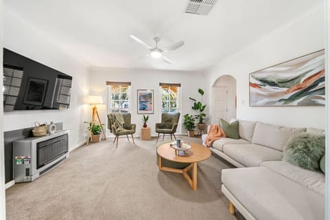 Unwind in the airy living area with comfortable seating, a TV and soft natural light, creating an inviting space to relax after the beach, with air conditioning and heating for year-round comfort.