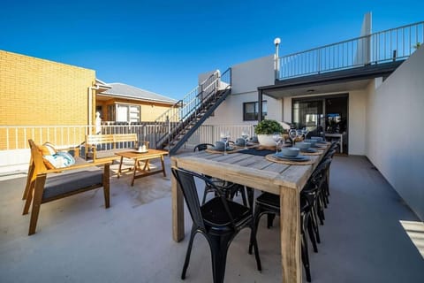Dine under open skies on the private rooftop terrace, where a large table sets the scene for long, relaxed meals with friends and family.