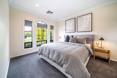 Wake to soft natural light in the primary bedroom, where a king bed offers a calm and restful retreat.