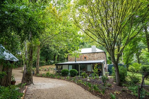 The home’s stone exterior blends seamlessly into the tree-filled surroundings.