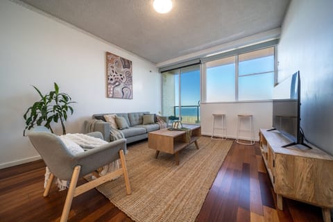 Unwind in the living area as natural light pours in and ocean views stretch beyond the windows.
