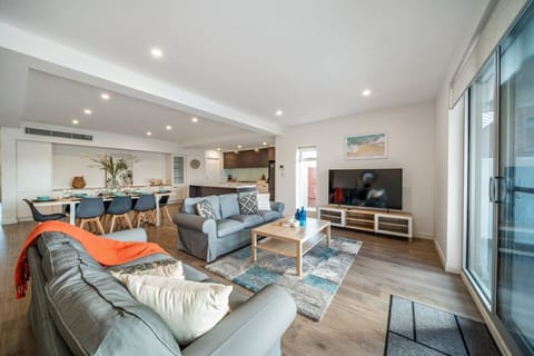 Stretch out on the soft sofas as natural light fills the open living space, with a large TV ready for relaxed evenings in.