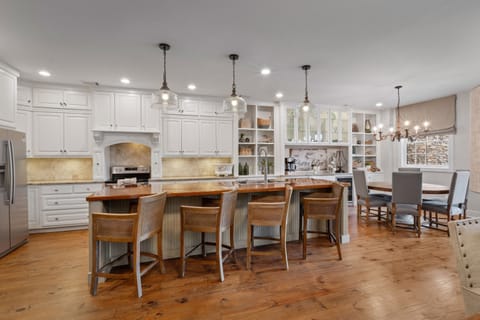 The large kitchen island with extra seating is perfect for casual dining, morning coffee, or gathering while meals are prepared.