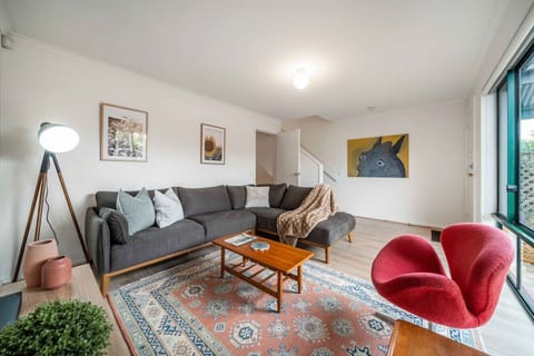 Unwind in the inviting living room, where soft tones, natural light, and plush seating make it easy to relax.