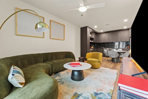Stretch out in the inviting living room with a plush sofa, oversized TV, and modern design touches throughout.