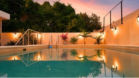 Outdoor pool, open 7:00 AM to 10:00 PM, pool umbrellas