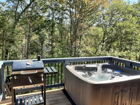 Private deck with hot tub and charcoal grill.