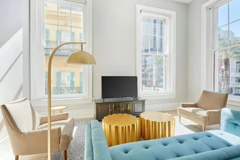 Bright and airy living room with plush seating and a TV to keep you entertained.