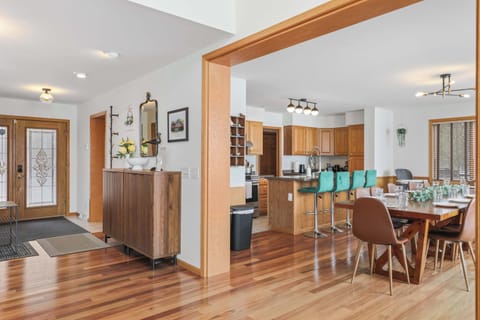 View from living room looking int the dining/kitchen area with front entrance on the left