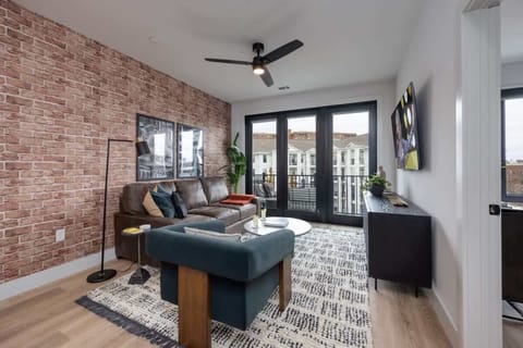 Relax and unwind in this inviting living room, perfect for entertaining with a large TV and private balcony.