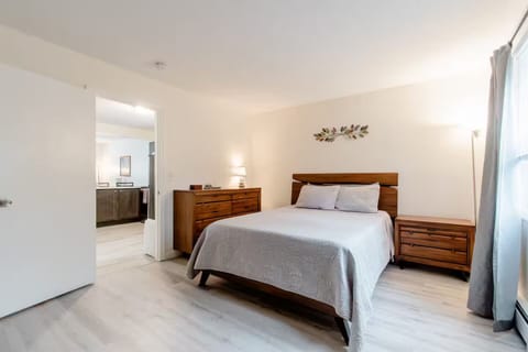 Spacious Queen bedroom equipped with bed essentials and toiletries