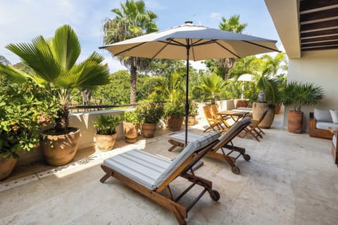 Luxury Punta Mita terrace with sun loungers and lush tropical views