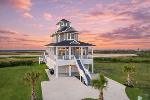 Luxury coastal beach house in Galveston TX with elevated design, panoramic marsh views, and private driveway near the Gulf.