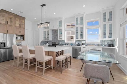 Fully equipped gourmet kitchen with modern appliances, spacious island, and open layout for entertaining.