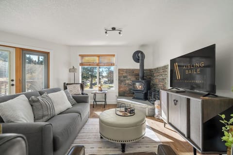 Living room with a wood-burning fireplace, smart TV, board games & cozy seating