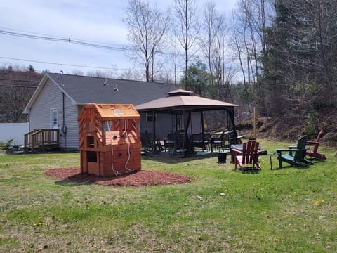 View of backyard with outdoor seating and fire pit