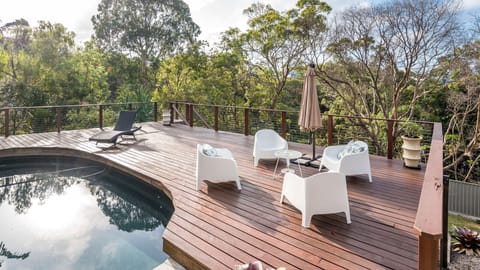 Private pool deck surrounded by native trees