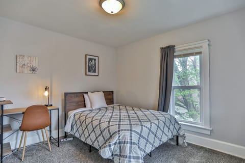 Bright and comfortable bedroom featuring soft carpeting, neutral finishes, and a large window with pleasant natural light.