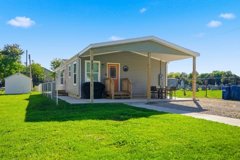 Front of the property with plenty of parking for multiple vehicles, outdoor seating area and grill